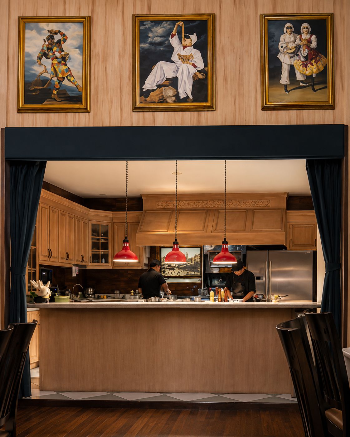 Commedia dell'Arte paintings above the open kitchen